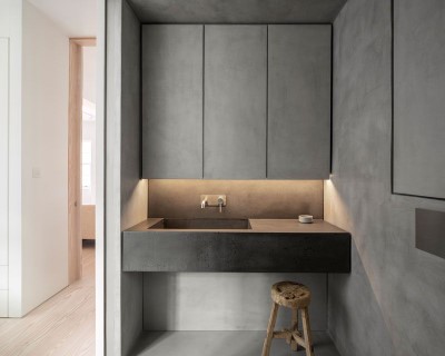 Sleek microcement bahtroom cupboards and concrete sink.
