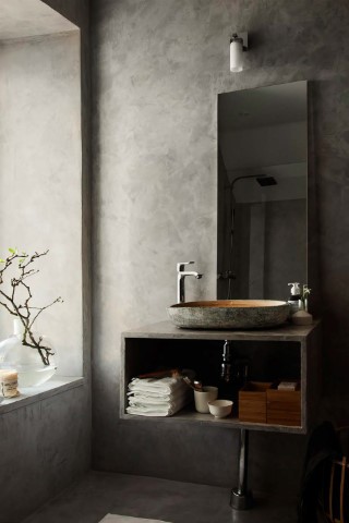 Dark microcement bathroom
